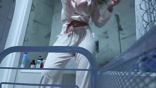 A girl caresses her pussy in the bathroom, craving no one to see it