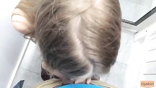 Public blowjob in the changing room of a shop, risking to be caught