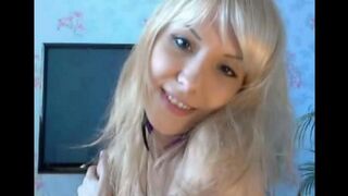 A blonde woman plays with her pussy using her fingers