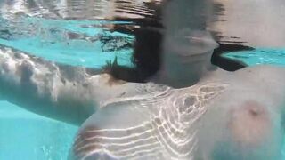 Girl plays with dildo in the swimming pool