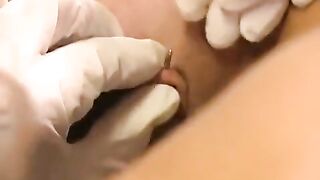 A girl with a clitoral piercing plays with sex toys and gets wet