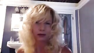 A hot woman over 50 years old has sex with herself in the bathroom
