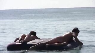 A naked girl is having fun on the beach with others