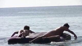 A naked girl is having fun on the beach with others
