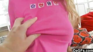A cute young blonde plays with her panties before a surprised man