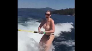 Topless beauty riding on the water skiing is very exciting