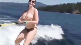 Topless beauty riding on the water skiing is very exciting