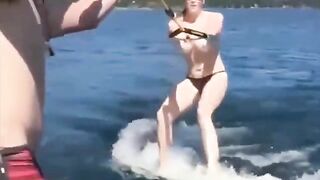 Topless beauty riding on the water skiing is very exciting