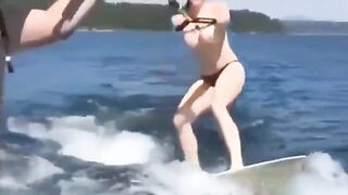 Topless beauty riding on the water skiing is very exciting
