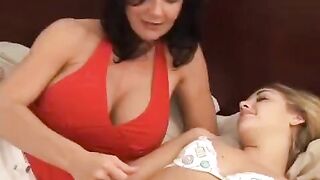 Two young girls are having fun with their older friends using a strap-on