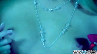 A blonde girl caresses herself with a big yellow dildo