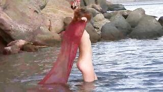 Nude beauty with small boobs walking in the rain