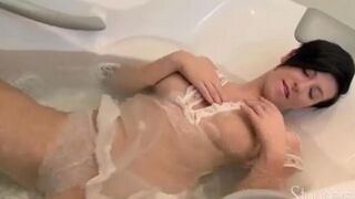 A lonely pregnant brunette caresses her stomach while masturbating on the couch