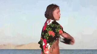 The member shows a girl in a nudist beach scene