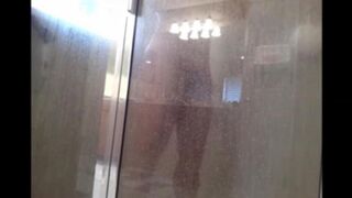 A guy washes his body with a hidden camera in the shower