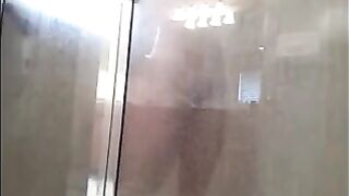 A guy washes his body with a hidden camera in the shower