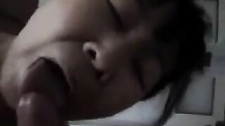A Chinese woman practices her blowjob skills on her man in a steamy homemade scene