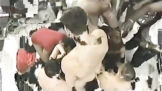 A crowd of people fucks a young chick with big tits hard
