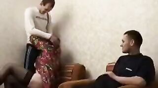 A mature woman fucks her son's friend, trying not to be noticed