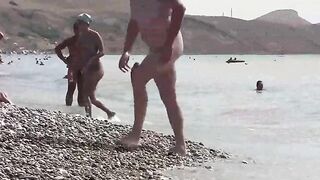 Nudist paradise in Crimea. A girl is walking naked on the coast