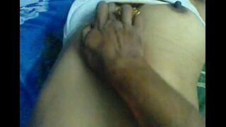 The husband makes a massage for the nipples of his wife