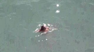 A couple enjoy each other in a completely naked form right in the middle of the sea