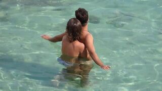 A girl playing with a guy’s cock while they are underwater