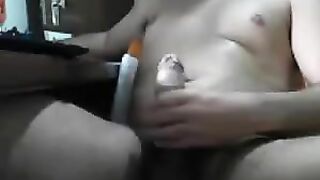 A guy sits at the computer and masturbates his cock