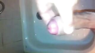 The kid masturbates his dick under a shower jet