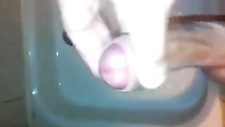 The kid masturbates his dick under a shower jet
