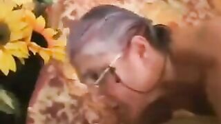 A man has sex with a gray-haired woman in black stockings, exciting the girl
