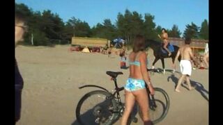 Nudist girl has fun on the beach without any clothes