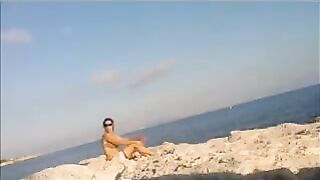 A young girl sunbathes naked on the beach. It's not every day