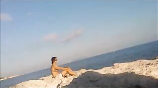 A young girl sunbathes naked on the beach. It's not every day