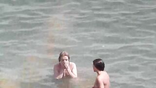 A group of naked beauties are having fun in the sea water