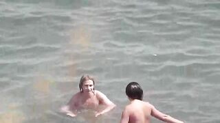 A group of naked beauties are having fun in the sea water