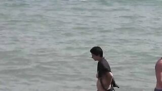 A group of naked beauties are having fun in the sea water