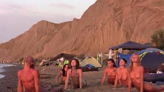 A sexy game of volleyball with naked beauties on the beach
