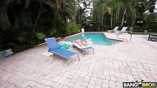 A girl is having fun in the pool with a man who resembles her dad