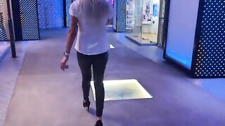 The girl is ready to do everything to make a sale in the mall