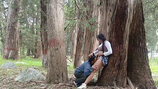 A pretty woman is being caressed in the forest