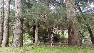 A pretty woman is being caressed in the forest