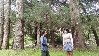 A pretty woman is being caressed in the forest