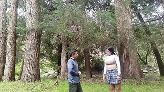 A pretty woman is being caressed in the forest