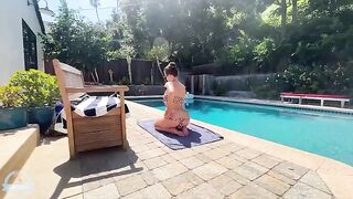 A big-breasted blonde bares her huge boobs by the pool
