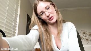 A girl with glasses puts on lipstick, rubbing it on her lips in POV style