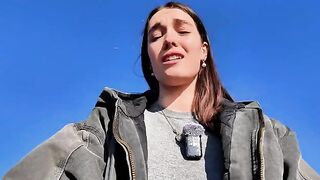 A petite brunette babe masturbates outdoors on a risky beach walk